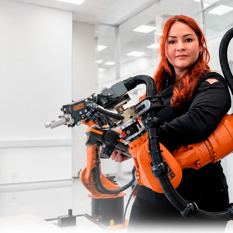 Vanessa Loiola working with an industrial robot